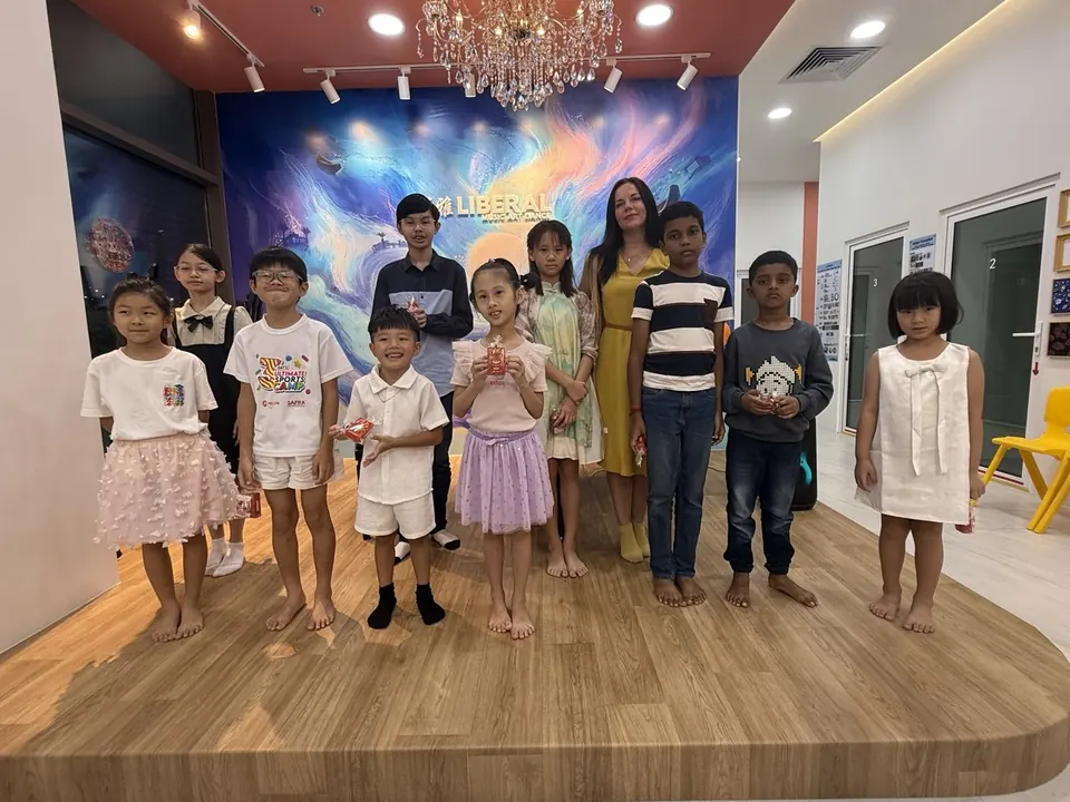 Students and their teacher on the stage at Tengah HQ after the recital