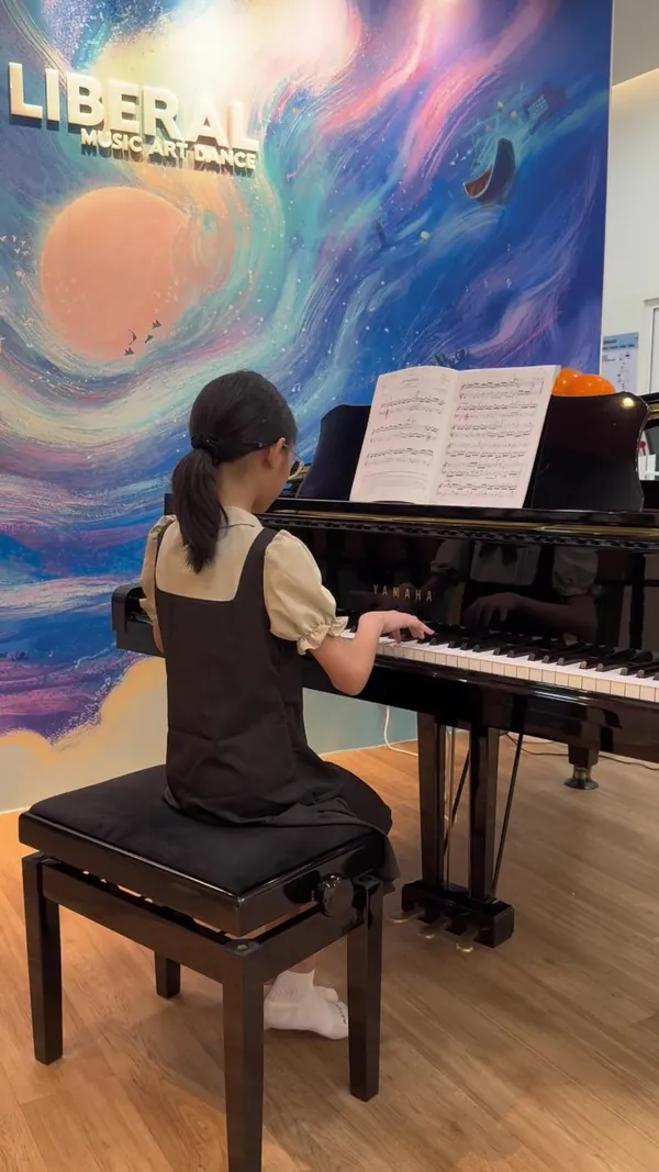 Piano student performing on the grand piano at Liberal Music & Arts School's Tengah HQ studio