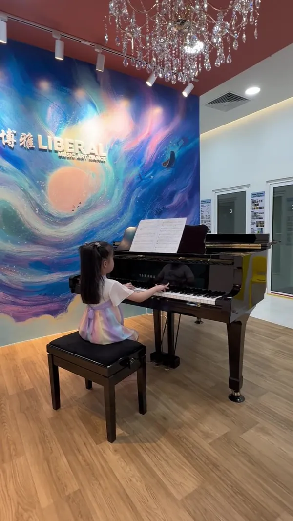 Young piano student playing the grand piano at Liberal Music & Arts School's Tengah HQ studio